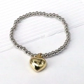 Elastic beaded bracelet with silver round beads and a gold heart-shaped pendant detail - Silver