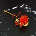 Single 24k gold foil artificial rose with red petals on a black marble background - Rainbow Gold Foil Rose - Red