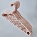 Stack of anti-slip Morandi pink plastic hangers for clothes with space-saving hooks - Lotus root pink