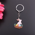 Detail of Easter keychain with white bunny and colorful eggs in nest on black background - Standing Rabbit