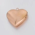 Polished 316L rose gold stainless steel heart locket pendant with a reflective mirror finish - Rose Gold