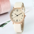 Minimalist ultra-thin quartz watch with beige leather strap and gold case on a pink pedestal - Beige
