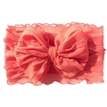 Detail of coral lace baby headband featuring large layered bow and elastic fabric - Watermelon red