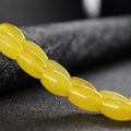 Strand of polished yellow agate beads in a smooth barrel shape for DIY jewelry making - Light Topaz Jade