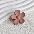 Detail shot of matte flower hair claw clip in soft rose pink with smooth matte texture - Tan