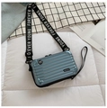Detail of light blue mini suitcase bag with rigid hardshell and striped texture - Light Blue