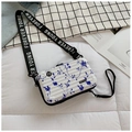 Detail of a white hard-shell mini suitcase bag with blue floral patterns and wide strap - White & Blue Floral