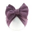 Knitted infant bow turban hat in vintage plum red on a mannequin head - Dark Purple