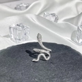Detail of silver snake ring with pavé diamonds and green gemstone eyes on stone - Style 4 Adjustable Ring
