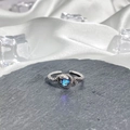 Detail of snake shaped silver ring with blue gemstone on slate and white silk background - Style 6 Adjustable Ring