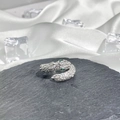 Detail of silver snake ring with green gem eyes and sparkling crystals on stone - No. 17 Open Ring