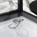 Detailed view of butterfly ring with blue gemstone on white silk in black jewelry box - Silver Fluid Butterfly Blue Gem Style (5)