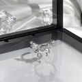 Detailed close-up of silver butterfly ring with clear gems on reflective display surface - Silver Butterfly Heart Gem Tassel Style (8)