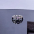 Detailed shot of star-shaped silver ring featuring a pink gemstone and micro-pave diamonds - Style 1 Star Open Ring