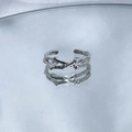 Close-up of a silver branch-shaped ring with a clear gem on a reflective surface - Style 4 (Branch Design)