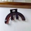 Détail d'une pince à cheveux en acétate marron avec le logo doré France Handmade - Marron Café