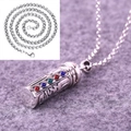 Detailed close-up of a silver cylinder pendant with colorful gems and embossed patterns - Pendant with Keel Chain