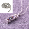 Macro detail of silver cylinder pendant with six colored stones on a metal chain - Pendant with Twist Chain