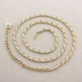 Detail of golden metal chain belt with white leather weave and large pearl pendant charm - White