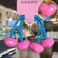 Detail of four pink heart charms on blue elastic hair ties displayed on a card - Rose Red