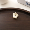 Close-up of a white mini floral hair clip on a vintage dark wooden tray with aesthetic decor - Off-white