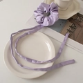 Elegant purple satin scrunchie with long ribbons displayed on a ceramic plate - Light Purple