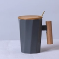 Grey geometric ceramic mug featuring an elegant wooden handle and matching lid with gold spoon - Decagonal Grey Mug with Lid & Spoon