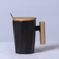 Nordic matte black ceramic mug with geometric facets, wooden handle and lid with gold spoon - Decagonal Black Mug with Lid & Spoon