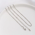 Detail of silver beaded chain with lobster clasp, adjustable extender and water drop pendant - Satellite Bead Chain / White Gold