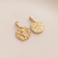 Detail of 14K gold plated Leo zodiac pendant with lion relief and textured finish - Leo