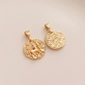 Macro shot of 14K gold-filled Sagittarius zodiac coin pendant with detailed starry engravings - Sagittarius