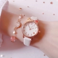 Detail of white cat-ear watch and gold moon bracelet set on a model's wrist - White + Star Moon Bracelet