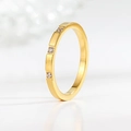 Close-up of a minimalist gold titanium steel ring featuring three sparkling inset diamonds - US 5 / Gold Triple Diamond