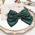 Forest green satin bow hair clip with triple layer design on a vintage mirror surface - Dark Green