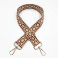 Detailed view of jacquard ethnic strap with geometric diamond patterns and gold metal hook - Dark Brown