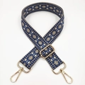 Detail of blue and beige geometric diamond pattern jacquard bag strap with gold metal hardware - Blue Base