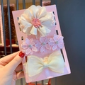 Close-up of three baby headbands with chiffon flowers and lace bows on a card - 3-22 Off-white Lace Combination