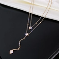 Detail of rose gold double-layered Y-necklace with three sparkling round crystals - Rose Gold