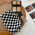 Macro shot of knitted checkerboard makeup bag featuring a durable zipper and soft texture - Black / Black and White Checkerboard