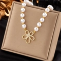 Elegant pearl necklace with a gold hollow floral pendant and sparkling crystals - White