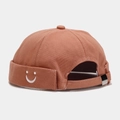 Detail of caramel cotton docker cap showing smiley embroidery and metal buckle - Adjustable / U Smile Dusty Pink