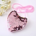 Detail view of pink heart-shaped sequin purse with matching woven shoulder strap - Pink