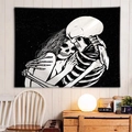 Gothic skull embrace tapestry in black and white hanging on a white wooden wall - Skeleton Couple Hugging