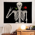 Detail of wall tapestry featuring black skull with red rose in an indoor home setting - Red Rose in Mouth Skeleton