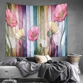 Detailed view of floral mountain tapestry with poppies hanging over a tidy bed - US 7