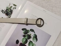 Beige leather belt with a circular metal buckle displayed on an aesthetic magazine - Round Buckle / Beige