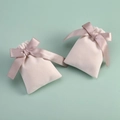 Two light pink velvet jewelry pouches with satin ribbon bows on a soft green background - 7x9cm / Off-White With Champagne Ribbon