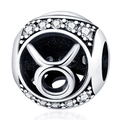 Macro shot of silver Taurus zodiac charm bead with white cubic zirconia inlay - Taurus