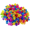 Close-up of colorful mini flower hair claws in a variety of vibrant plastic shades - Hollow Flower Style