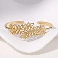 Elegante brazalete dorado de acero inoxidable con diseño creativo de hojas caladas - Dorado